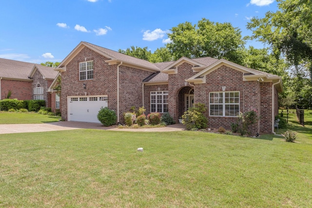 5019 John Hagar Rd, Hermitage, TN 37076 - view of front of home featuring brick siding, driveway, a garage, and a front lawn