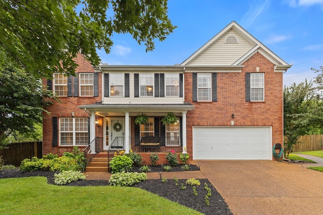 2684 Wind Dance Ct, Spring Hill, TN 37174 - view of front facade featuring a garage, concrete driveway, covered porch, and brick siding