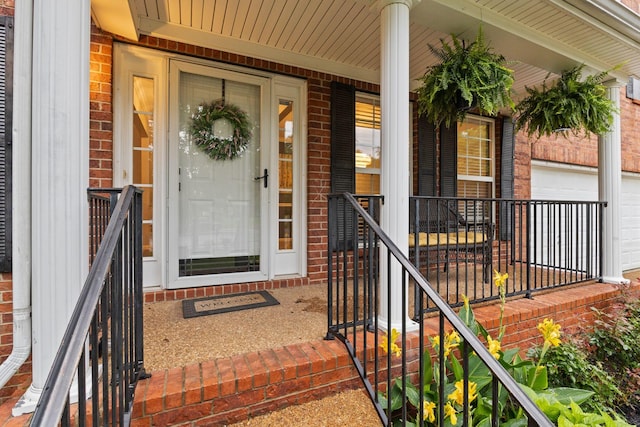 2684 Wind Dance Ct, Spring Hill, TN 37174 - entrance to property with brick siding, an attached garage, and a porch