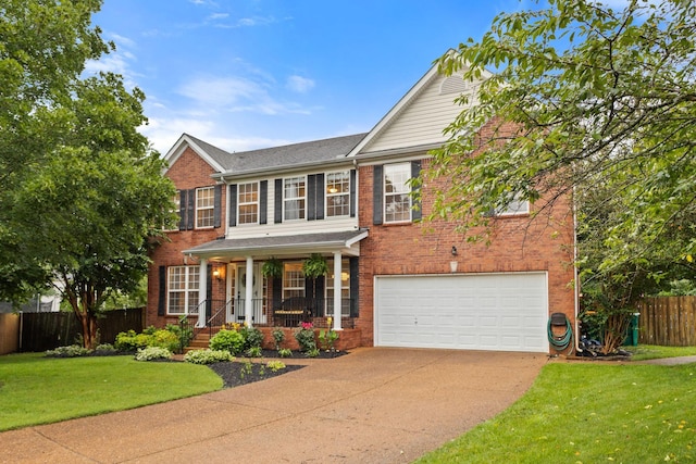 2684 Wind Dance Ct, Spring Hill, TN 37174 - view of front of house with brick siding, concrete driveway, a porch, and a garage