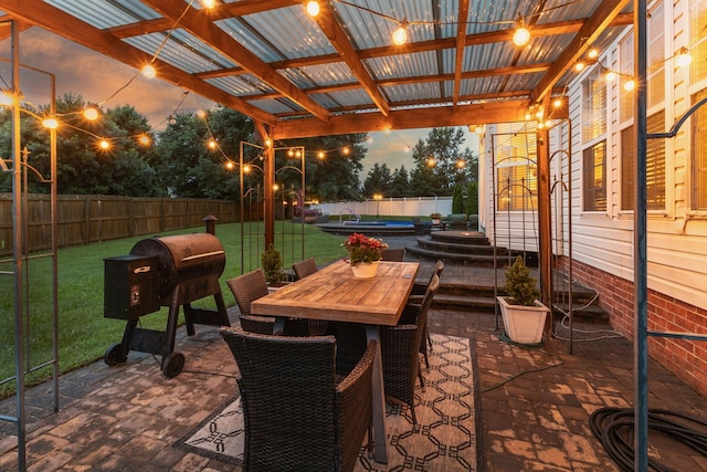 2684 Wind Dance Ct, Spring Hill, TN 37174 - patio terrace at dusk featuring a patio, a fenced backyard, and outdoor dining space