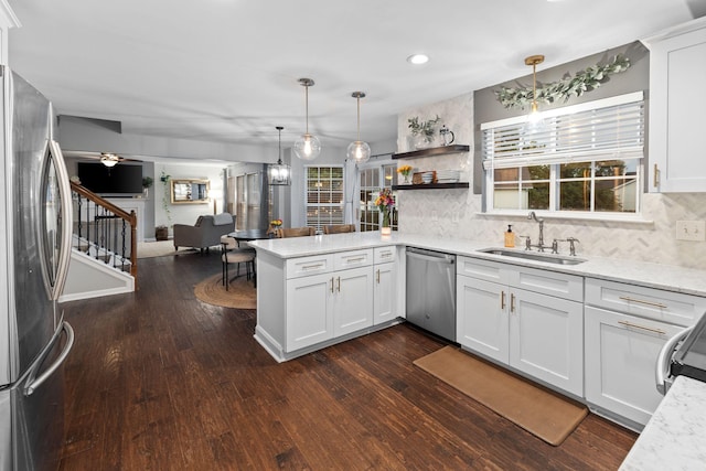 2684 Wind Dance Ct, Spring Hill, TN 37174 - kitchen featuring appliances with stainless steel finishes, a peninsula, open floor plan, decorative backsplash, and recessed lighting