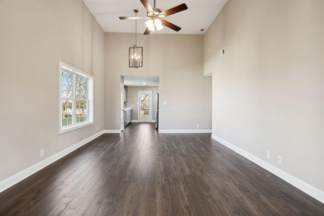 413 Stein St, Oak Grove, KY 42262 - unfurnished living room with a ceiling fan, a high ceiling, a chandelier, and dark wood-type flooring