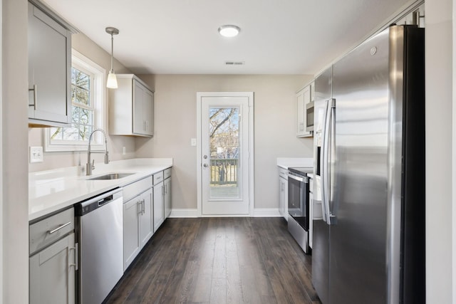413 Stein St, Oak Grove, KY 42262 - kitchen with appliances with stainless steel finishes, dark wood-style flooring, light countertops, hanging light fixtures, and gray cabinetry