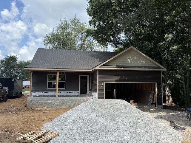 413 Stein St, Oak Grove, KY 42262 - view of front facade featuring covered porch, gravel driveway, a garage, and roof with shingles