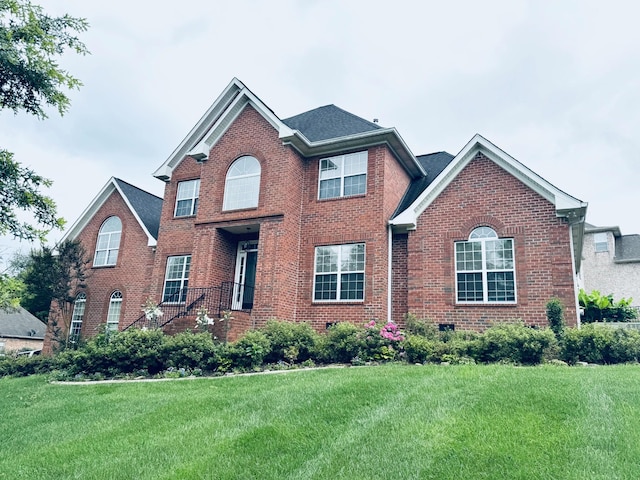 1046 Island Brook Dr, Hendersonville, TN 37075 - traditional-style house featuring brick siding and a front lawn