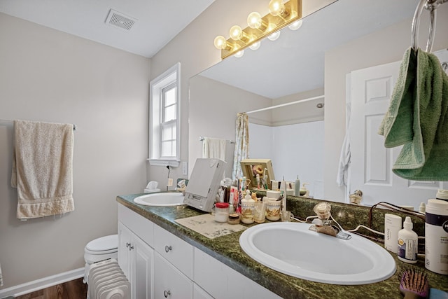 2106 Debbie Ln, La Vergne, TN 37086 - full bath with double vanity, curtained shower, wood finished floors, and radiator heating unit