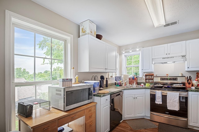 2106 Debbie Ln, La Vergne, TN 37086 - kitchen featuring appliances with stainless steel finishes, under cabinet range hood, white cabinetry, and wood finished floors