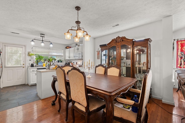 1857 Brookmeadow Ln, Hermitage, TN 37076 - dining space with hardwood / wood-style floors, a chandelier, and a textured ceiling