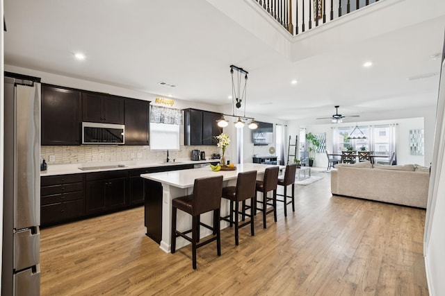 809 Old Blue Ln, Murfreesboro, TN 37130 - kitchen featuring stainless steel appliances, light countertops, a breakfast bar area, recessed lighting, and light wood finished floors