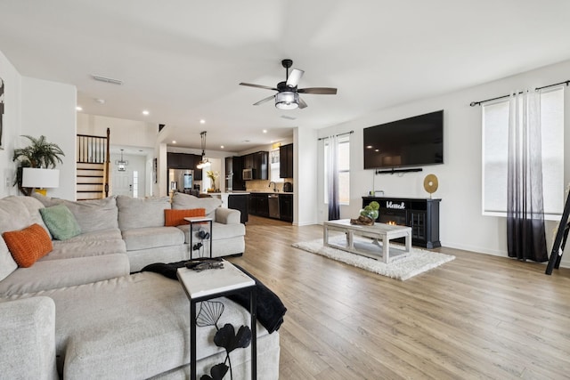 809 Old Blue Ln, Murfreesboro, TN 37130 - living area featuring stairway, ceiling fan, light wood-style flooring, a lit fireplace, and recessed lighting