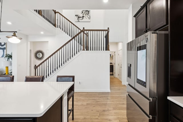 809 Old Blue Ln, Murfreesboro, TN 37130 - kitchen featuring stainless steel fridge, light wood-style floors, light countertops, recessed lighting, and a breakfast bar