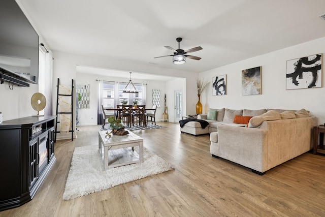 809 Old Blue Ln, Murfreesboro, TN 37130 - living area with wood finished floors, a ceiling fan, a chandelier, and a barn door