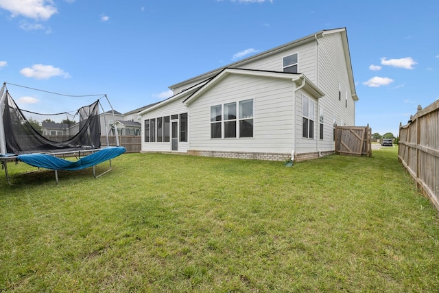809 Old Blue Ln, Murfreesboro, TN 37130 - rear view of property featuring a trampoline, a fenced backyard, and a sunroom