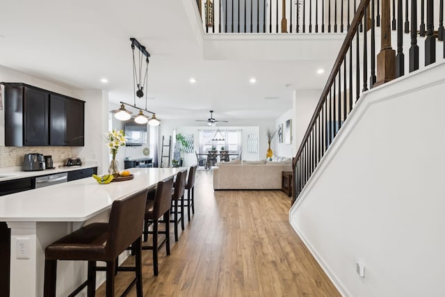 809 Old Blue Ln, Murfreesboro, TN 37130 - kitchen with light countertops, a breakfast bar area, recessed lighting, light wood-style floors, and a center island