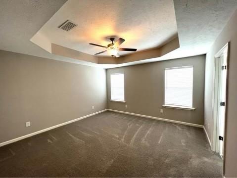 5225 Normandy Cob Dr Unit 33, Murfreesboro, TN 37129 - unfurnished room with a tray ceiling, dark colored carpet, a ceiling fan, and a textured ceiling