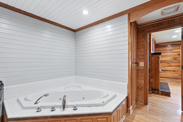 1880 Clydeton Rd, Waverly, TN 37185 - bathroom featuring wooden walls, a jetted tub, ornamental molding, wood finished floors, and recessed lighting