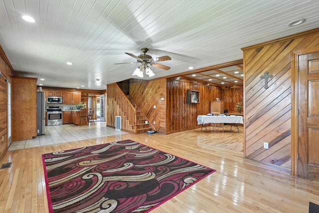 1880 Clydeton Rd, Waverly, TN 37185 - living area with wood walls, light wood-style flooring, stairway, a ceiling fan, and recessed lighting