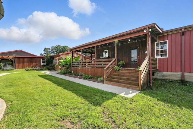 1880 Clydeton Rd, Waverly, TN 37185 - rear view of property with board and batten siding, a lawn, and a porch
