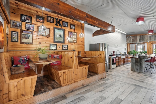 1880 Clydeton Rd, Waverly, TN 37185 - dining space featuring wood walls and light wood-type flooring