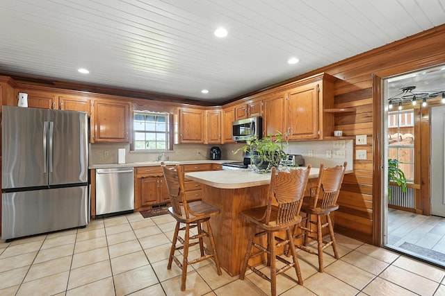 1880 Clydeton Rd, Waverly, TN 37185 - kitchen with stainless steel appliances, light countertops, light tile patterned flooring, a peninsula, and brown cabinetry
