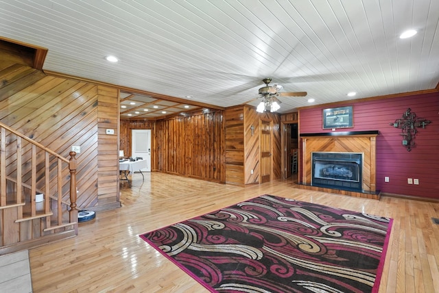 1880 Clydeton Rd, Waverly, TN 37185 - unfurnished living room featuring wood walls, a tile fireplace, stairs, wood-type flooring, and recessed lighting