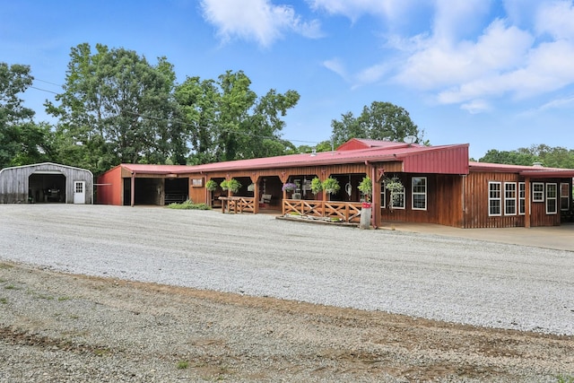 1880 Clydeton Rd, Waverly, TN 37185 - view of front of home featuring a metal roof, an outdoor structure, a detached carport, and driveway
