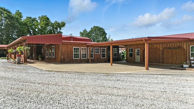 1880 Clydeton Rd, Waverly, TN 37185 - rear view of property with an attached carport, a metal roof, and gravel driveway