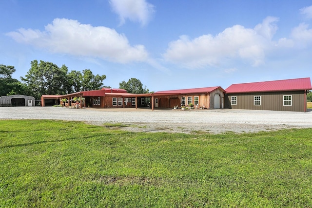 1880 Clydeton Rd, Waverly, TN 37185 - view of front of home with a front yard, a metal roof, and an outdoor structure