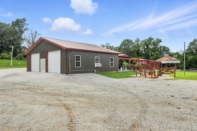 1880 Clydeton Rd, Waverly, TN 37185 - view of property exterior with a metal roof, a garage, an outbuilding, and a gazebo