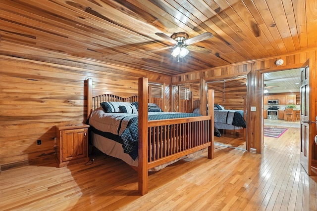 1880 Clydeton Rd, Waverly, TN 37185 - bedroom featuring wooden ceiling, wooden walls, and light wood-style floors