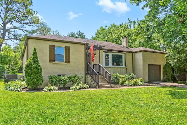 1207 Trotwood Ave, Columbia, TN 38401 - view of front of house featuring an attached garage, a chimney, a front yard, and brick siding