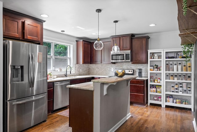 1207 Trotwood Ave, Columbia, TN 38401 - kitchen featuring stainless steel appliances, wood finished floors, tasteful backsplash, pendant lighting, and recessed lighting