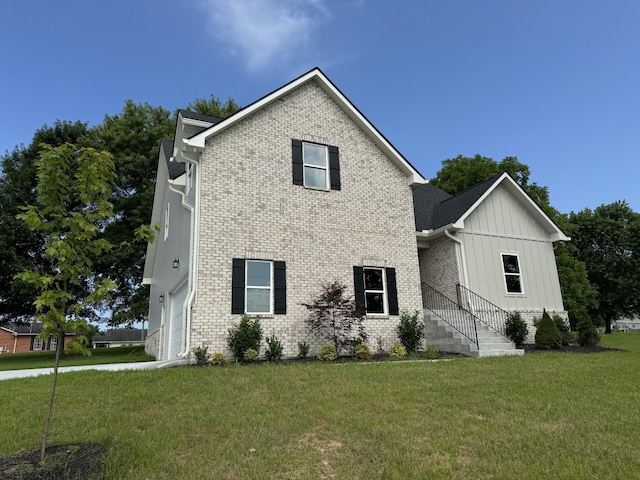 65 Misty Ln, Castalian Springs, TN 37031 - view of front of home featuring board and batten siding, a front lawn, and brick siding