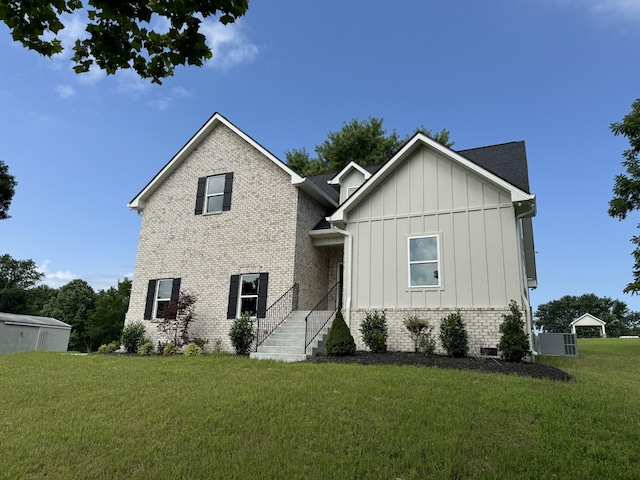 65 Misty Ln, Castalian Springs, TN 37031 - view of front facade featuring board and batten siding, a front yard, and brick siding