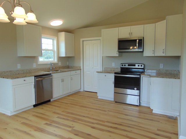 369 Brace Loop, Summertown, TN 38483 - kitchen featuring appliances with stainless steel finishes, light wood-style floors, white cabinetry, lofted ceiling, and a chandelier