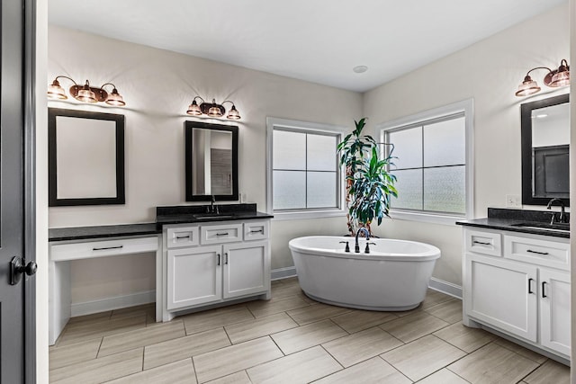 268 Planters Cir, Leoma, TN 38468 - full bathroom with two vanities, a soaking tub, and wood finish floors