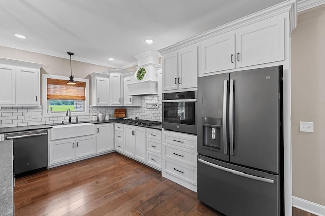 268 Planters Cir, Leoma, TN 38468 - kitchen featuring appliances with stainless steel finishes, dark countertops, dark wood-style flooring, white cabinets, and decorative backsplash