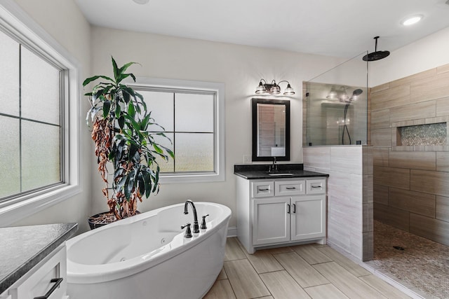 268 Planters Cir, Leoma, TN 38468 - full bathroom featuring vanity, a jetted tub, walk in shower, and healthy amount of natural light