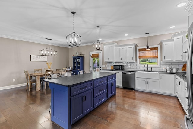 268 Planters Cir, Leoma, TN 38468 - kitchen with stainless steel dishwasher, dark countertops, blue cabinets, plenty of natural light, and recessed lighting