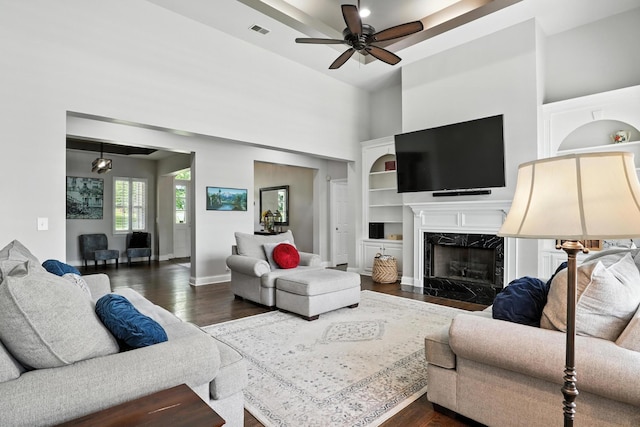 1069 Pleasant Valley Rd, Greenbrier, TN 37073 - living room with dark wood-style floors, ceiling fan, a high ceiling, and a premium fireplace