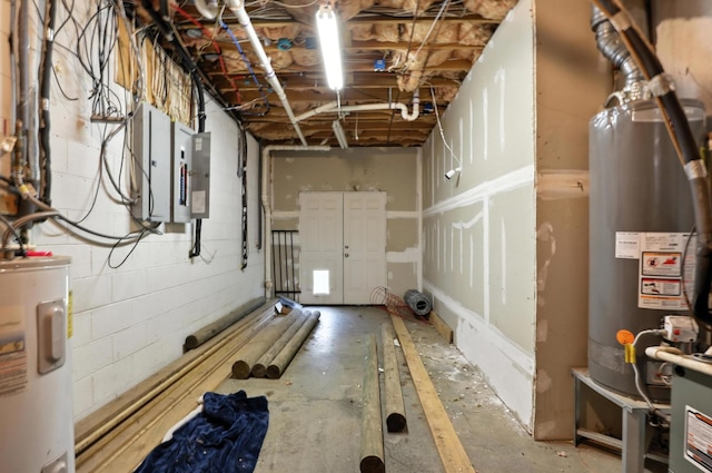 1069 Pleasant Valley Rd, Greenbrier, TN 37073 - unfinished basement featuring electric water heater, gas water heater, electric panel, and concrete block wall