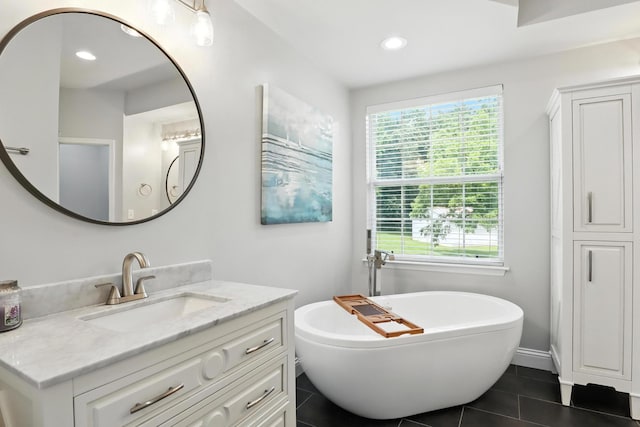 1069 Pleasant Valley Rd, Greenbrier, TN 37073 - bathroom featuring vanity, a soaking tub, tile patterned floors, healthy amount of natural light, and recessed lighting
