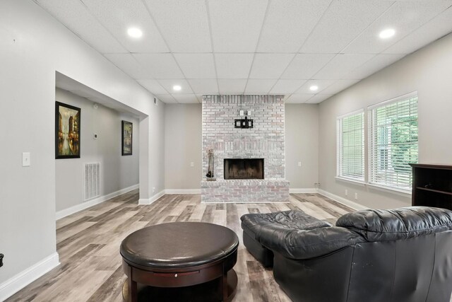 1069 Pleasant Valley Rd, Greenbrier, TN 37073 - living area with light wood-type flooring, a brick fireplace, and recessed lighting