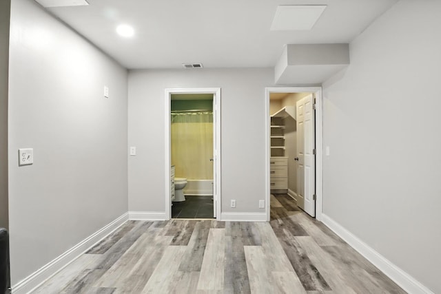 1069 Pleasant Valley Rd, Greenbrier, TN 37073 - unfurnished bedroom with wood finished floors, a spacious closet, ensuite bath, and a closet