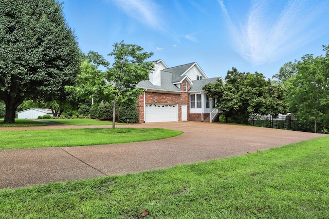 1069 Pleasant Valley Rd, Greenbrier, TN 37073 - view of front of property with brick siding, concrete driveway, a front lawn, and roof with shingles