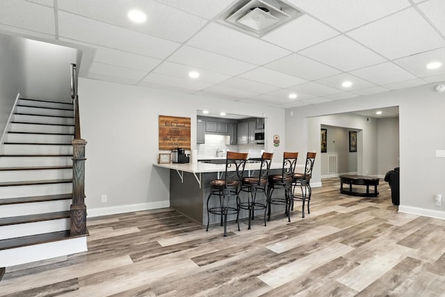 1069 Pleasant Valley Rd, Greenbrier, TN 37073 - kitchen featuring light wood-style flooring, a kitchen breakfast bar, light countertops, a peninsula, and recessed lighting