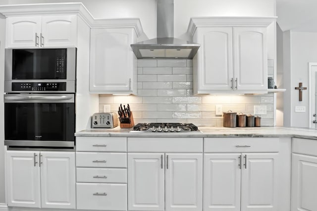 1069 Pleasant Valley Rd, Greenbrier, TN 37073 - kitchen featuring wall chimney exhaust hood, stainless steel appliances, white cabinets, and tasteful backsplash
