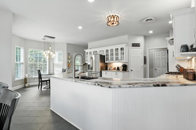 1069 Pleasant Valley Rd, Greenbrier, TN 37073 - kitchen with appliances with stainless steel finishes, white cabinetry, recessed lighting, glass insert cabinets, and a peninsula