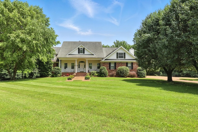 1069 Pleasant Valley Rd, Greenbrier, TN 37073 - view of front of home featuring a porch, a front lawn, a chimney, brick siding, and a shingled roof